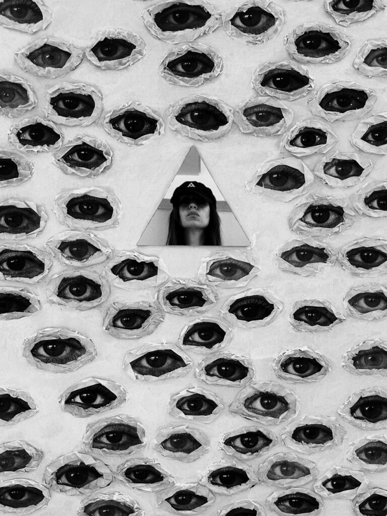Sofia Dell'Aversano Orabona, self-portrait framed by a collage of cut-out eyes